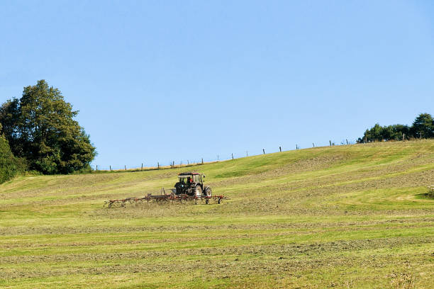istock Tractor with plough doing some agricultural seasonal work in field 666789486