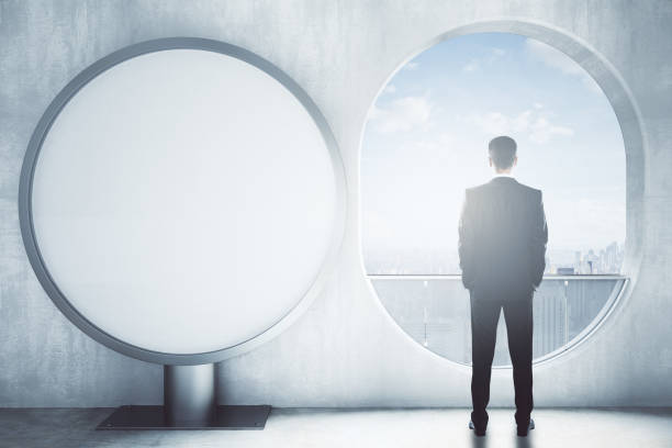 istock Man in room with round banner 666796246