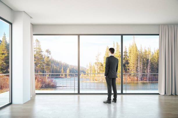 istock Man in room with landscape view 666799062