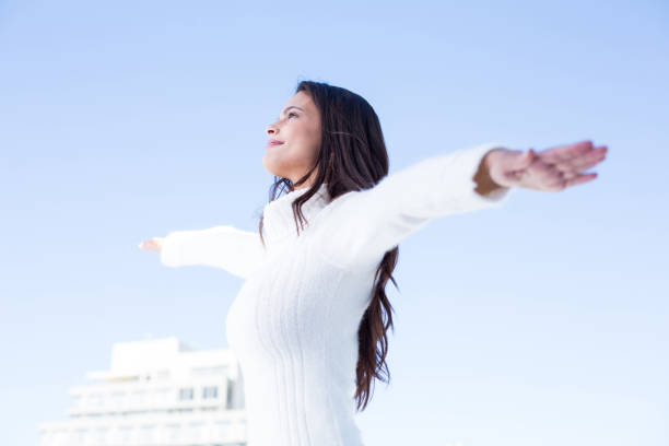 istock Pretty brunette feeling the air with arms raised up 666801616