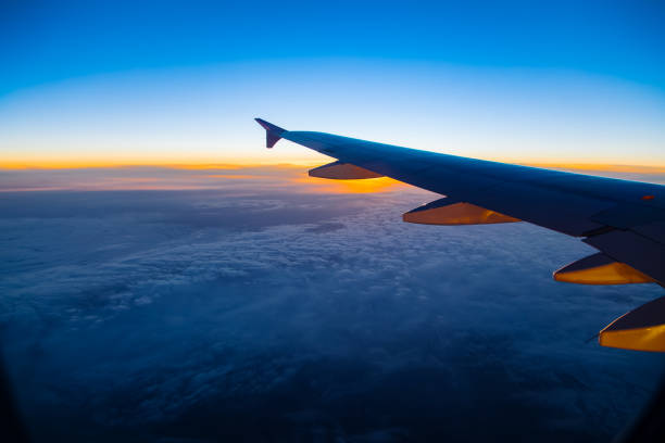 istock Aerial view from airplane window at sunset 666801878