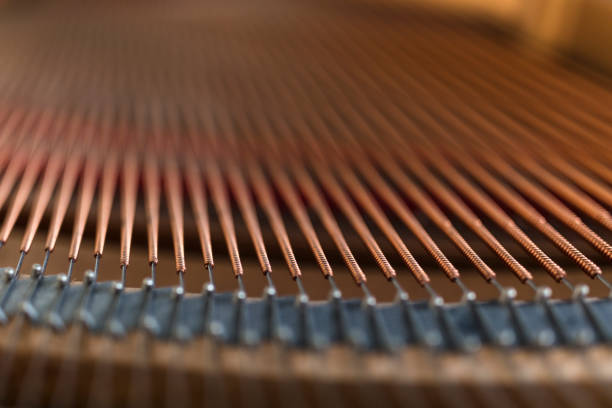 Inside wooden classic grand Piano mechanism with strings and keys details