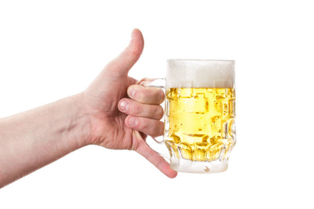 istock A mug of light beer in his hand. 666808244