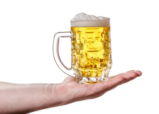 istock A mug of light beer in his hand. 666808310