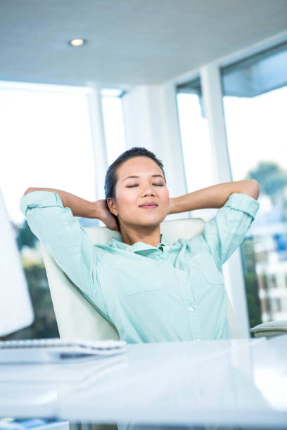 istock Smiling businesswoman with hands behind head 666817518