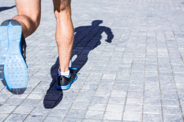 istock Close up view of athletes legs running 666817794