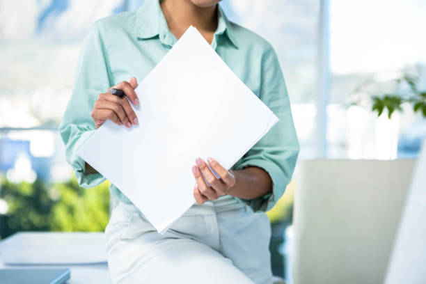 istock Smiling businesswoman sitting on her desk 666820596