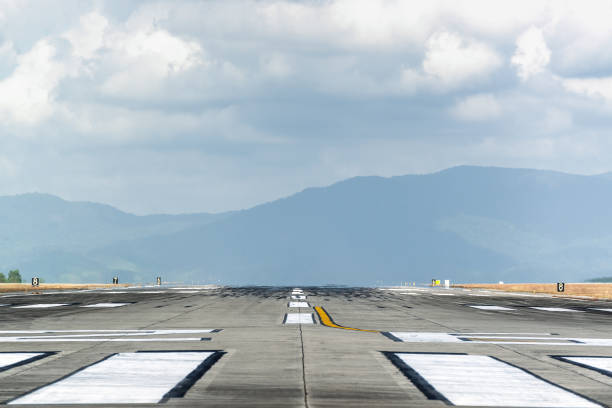 istock Runway with mountain in the background in cloudy day 666823358