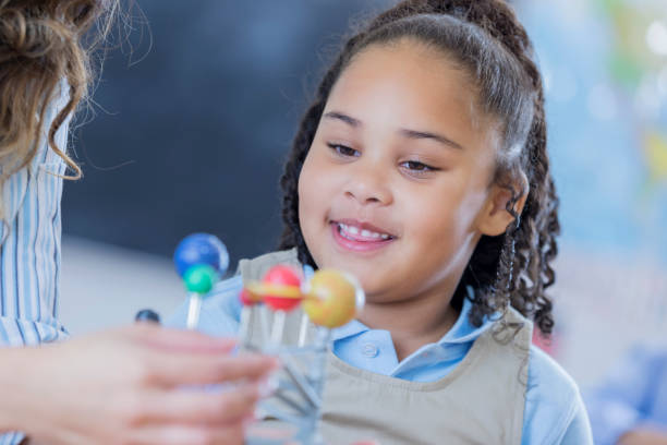 istock Adorable kindergarten student learns about the planets 666835588