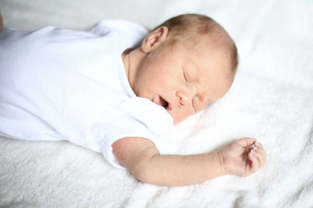istock cute newborn baby sleeping peacefully on white blanket 666845946