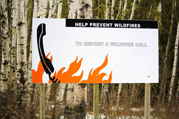 Helping prevent wildfire sign by reminding to call Helping prevent wildfire sign by reminding to call. deter stock pictures, royalty-free photos & images