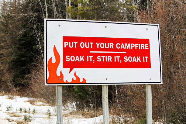 Reminder about putting out campfire sign Reminder about putting out campfire sign. deter stock pictures, royalty-free photos & images