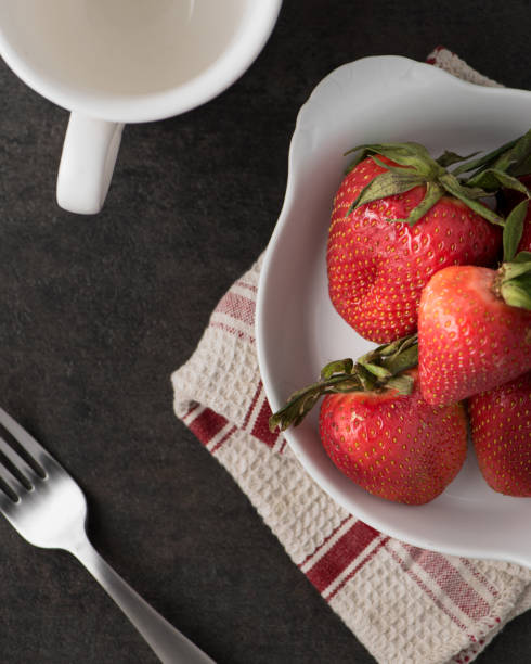 istock Strawberry pile with black stone 666871300