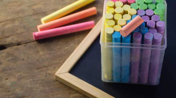 istock color chalks stick in a plastic box with chalkboard on wooden table 666882568
