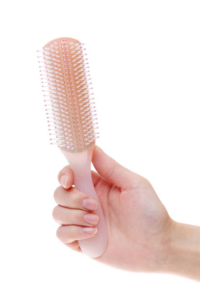 istock Hand holding hair brush 666883858