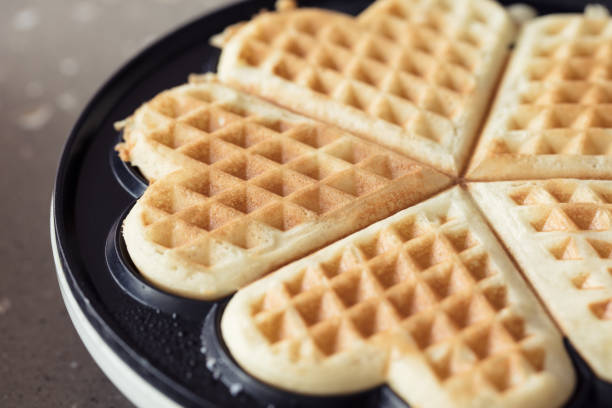 istock Freshly backed waffles in shape of heart, close up 666887138