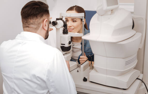 istock Professional male oculist sitting opposite his patient 666887914