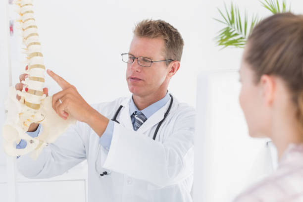 istock Doctor explaining anatomical spine to his patient 666890140