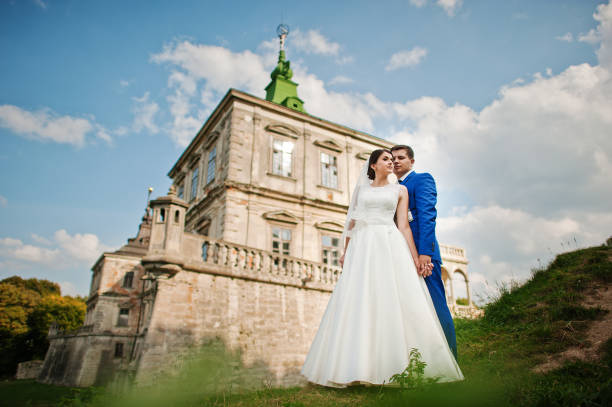 istock Young wedding couple on background old castle 666890614