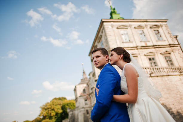 istock Young wedding couple on background old castle 666890632