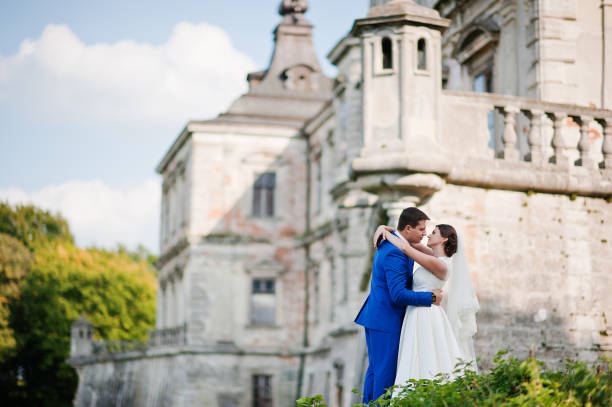 Young wedding couple on background old castle