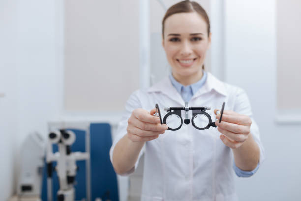 istock Eye test glasses being held by an optometrist 666890928