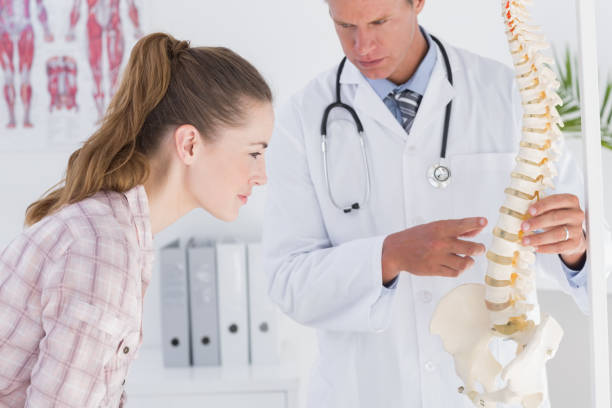 istock Doctor explaining anatomical spine to his patient 666890968