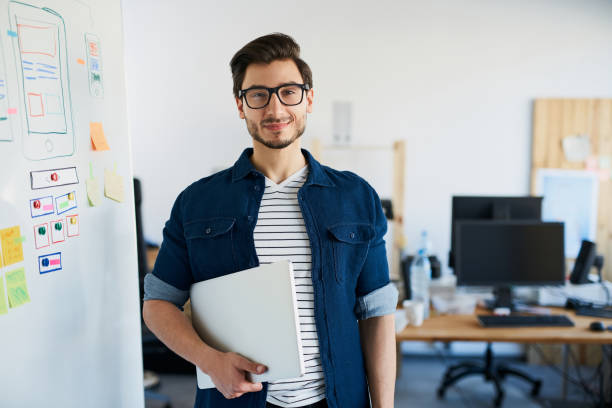 istock Happy designer, studnet standing with laptop at office, university 666891382