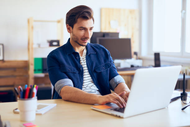 istock Men working on laptop at creative agency office 666891534