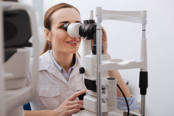 istock Nice female ophthalmologist focusing on her work 666893914