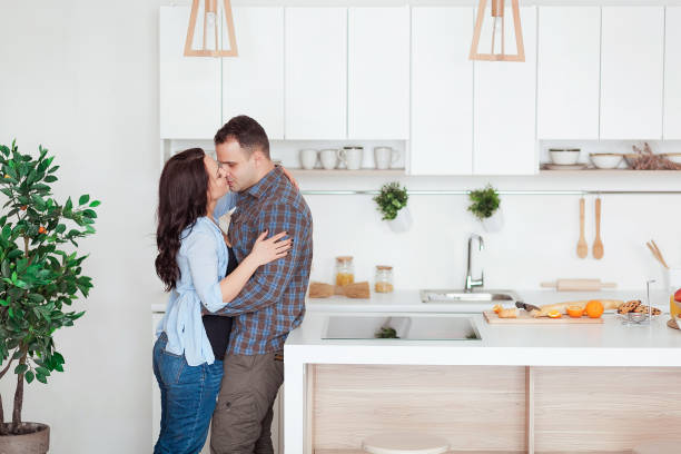 istock Happy couple hugging in the white loft stile kitchen 666897406