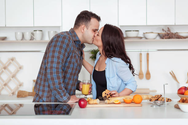 istock Young couple having a romantic breakfast at home in the kitchen 666897472