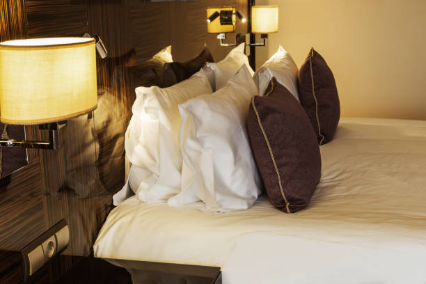istock Cushions and dressed bed linen on the bed 666897564