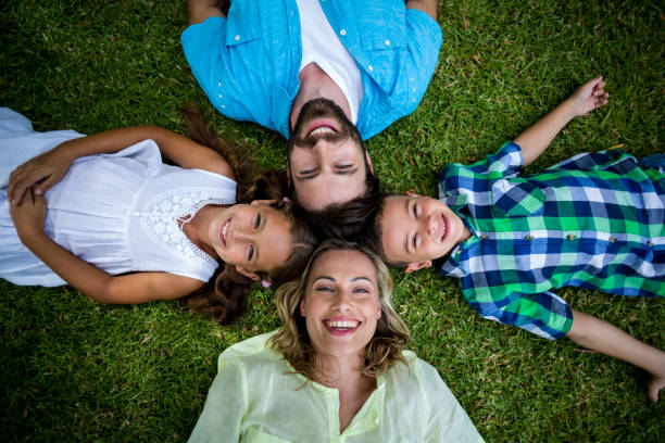 istock Happy family lying on grass in yard 666897676