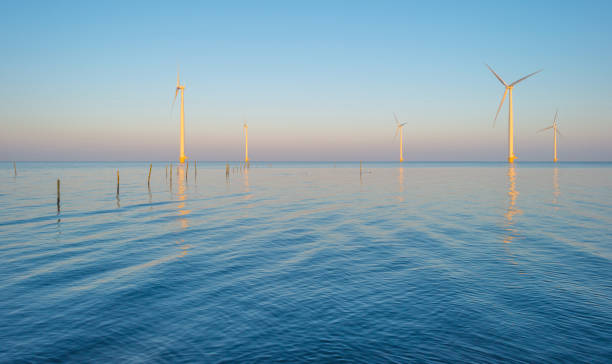 istock Wind turbines in a lake at sunrise 666904392