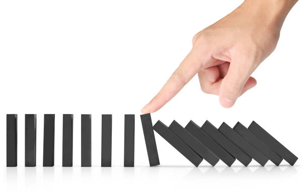 istock hand stop  dominoes continuous toppled 666904472