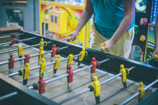 istock Friends having fun together playing table football. 666907626