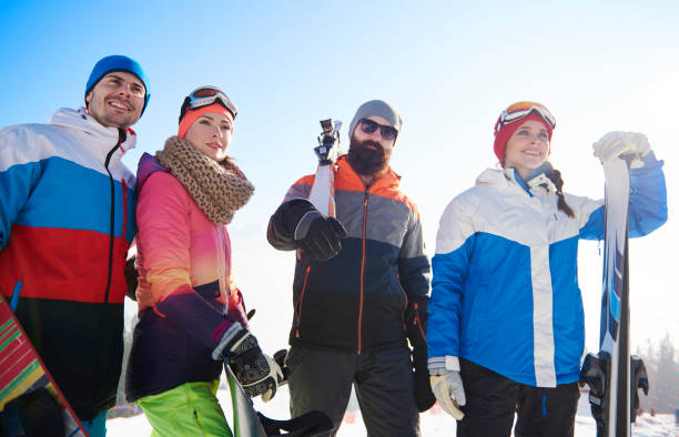 istock Happy mates with snowboards and skis 666908542
