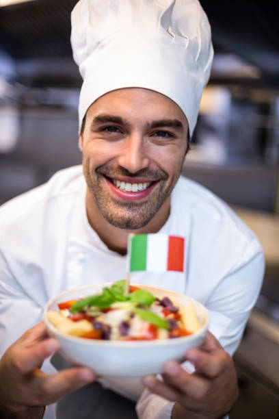 istock Handsome chef presenting meal with italian flag 666911726