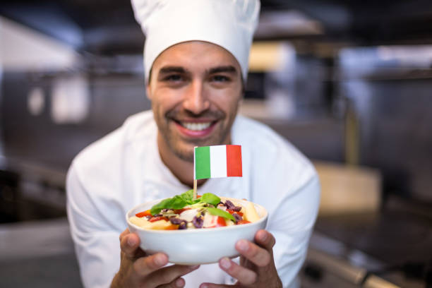 istock Handsome chef presenting meal with italian flag 666911822