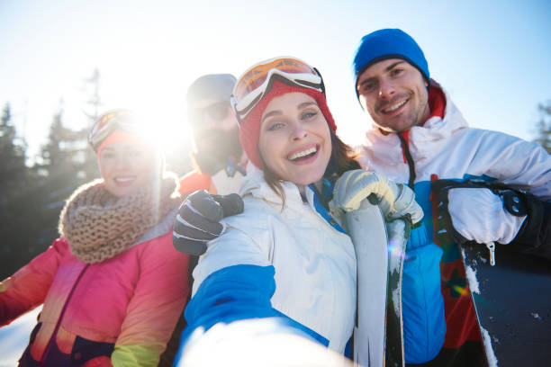 istock Group of four happy snowboarders 666912028