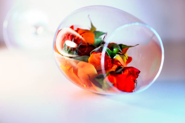 istock Glass vase filled with red rose petals. Aromatherapy concept. 666912134