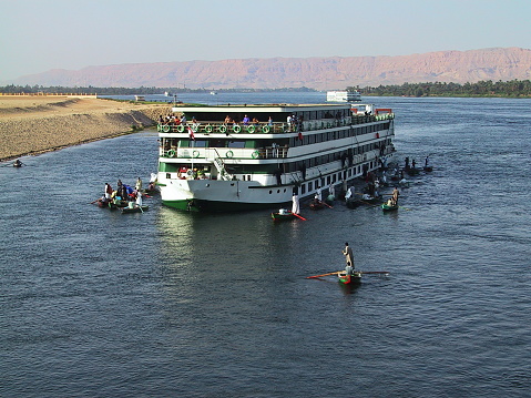 Nile river in Aswan, Egypt afternoon shot showing feluccas and boats in the river with elephantine Island (UNESCO World Heritage site)