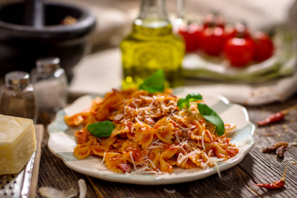 istock Pasta with tomato sauce on wooden background 666912510