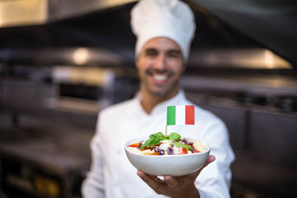 istock Handsome chef presenting meal with italian flag 666912534