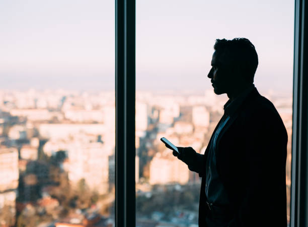 istock Businessman Texting At The Window 666915470