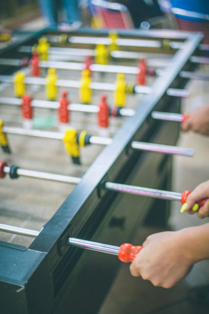 istock Friends having fun together playing table football. 666915564