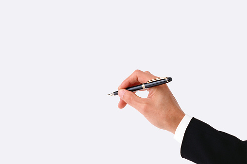 Close-up of hand writing with a pen isolated with clipping mask.