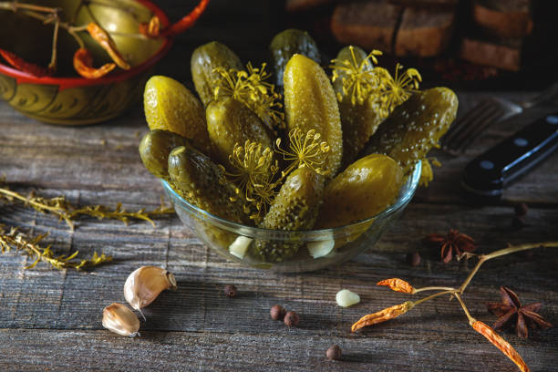istock Homemade cucumbers in a bowl over rustic wooden background 666919682