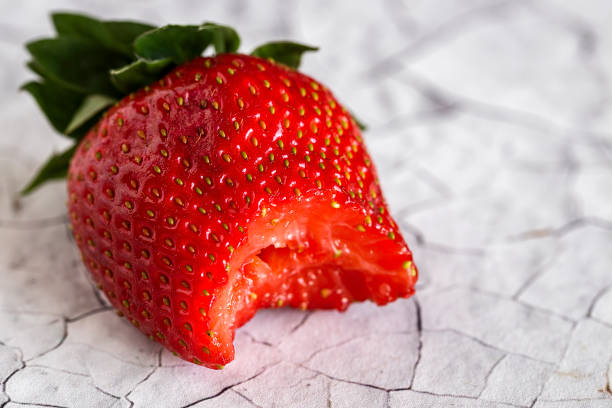 istock Fresh strawberries on old white wooden table 666930398